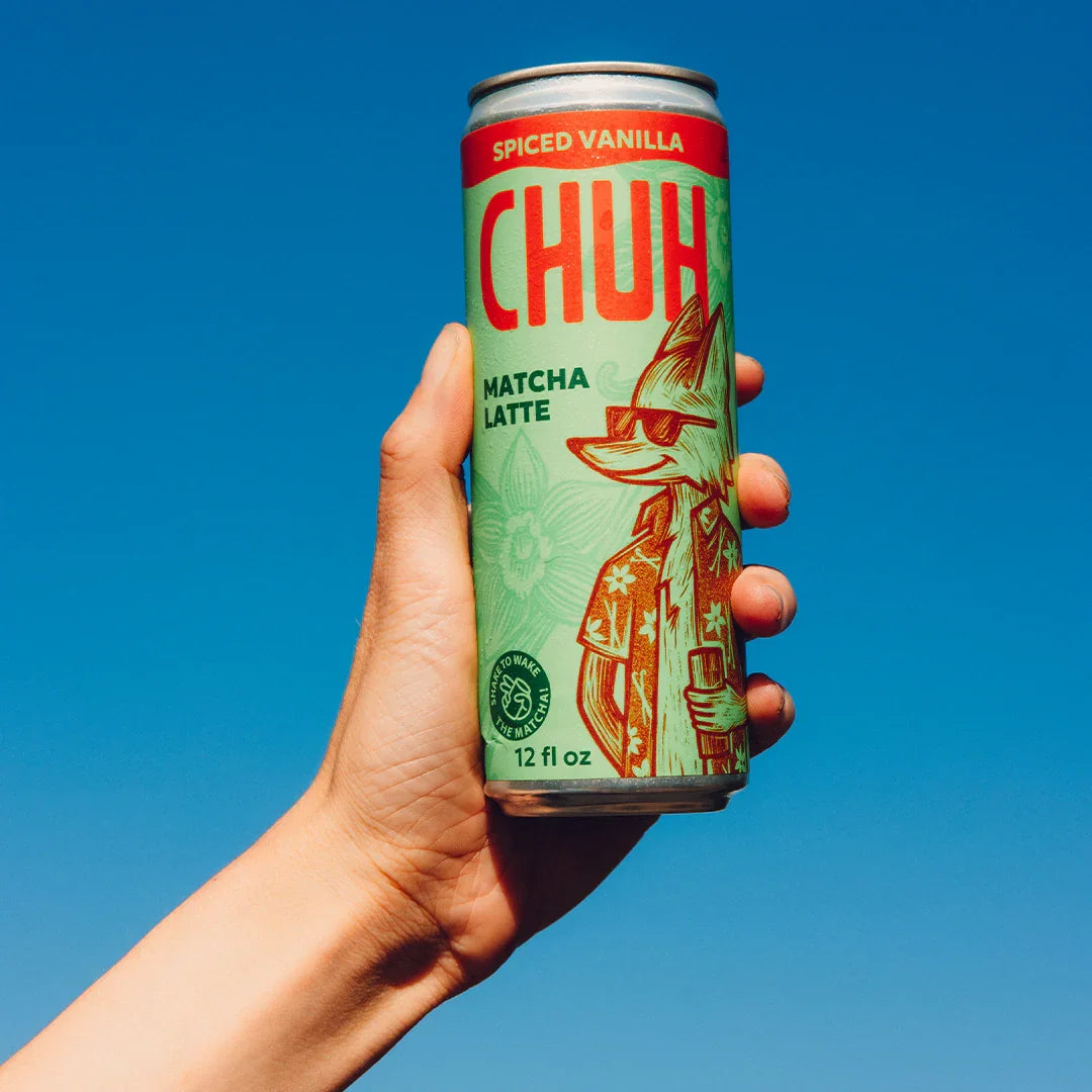 Hand holding a can of Chuh Spiced Vanilla Matcha Latte