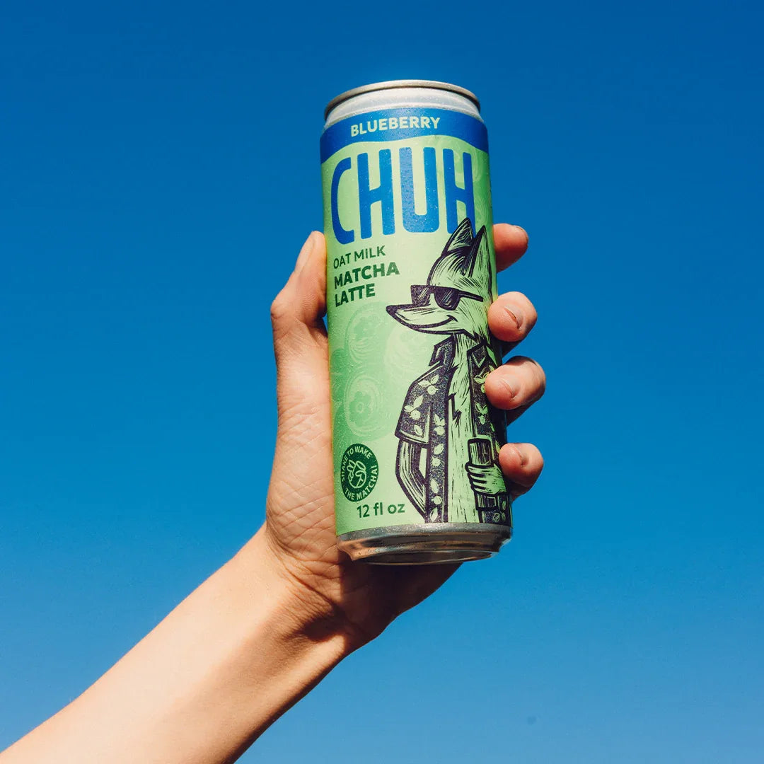 Hand holding a can of Blueberry CHUH Oat Milk Matcha Latte